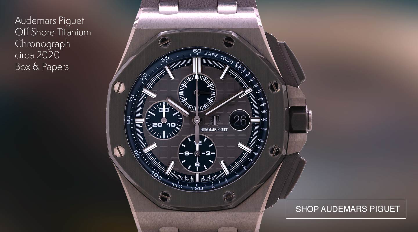 A stunning and mint condition preowned Audemars Piguet Titanium Royal Oak Offshore Chronograph ref 2640010 circa 2020. Featuring a robust 44mm case, brilliant grey baton dial, date function, and contrasting dark blue sub-dials. The Offshore accentuates the patented octagon bezel and 8 exposed screws. The chronograph pushers are functionally large, yet sleek.